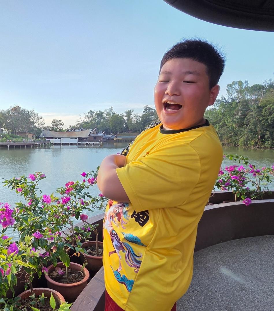 A child beside a lake on a sunny day